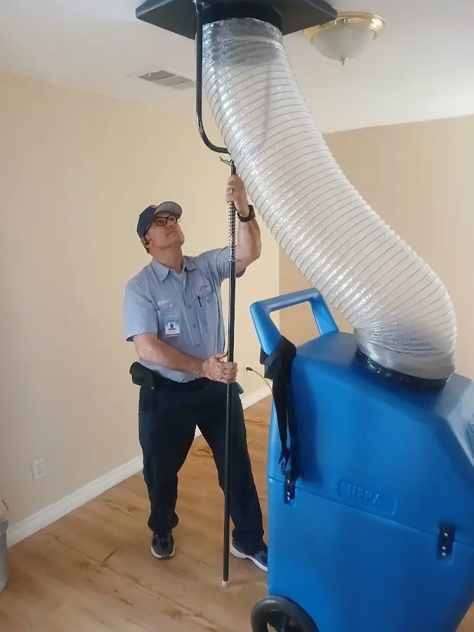 Furnace Tune-Up technician using HEPA equipment in San Clemente